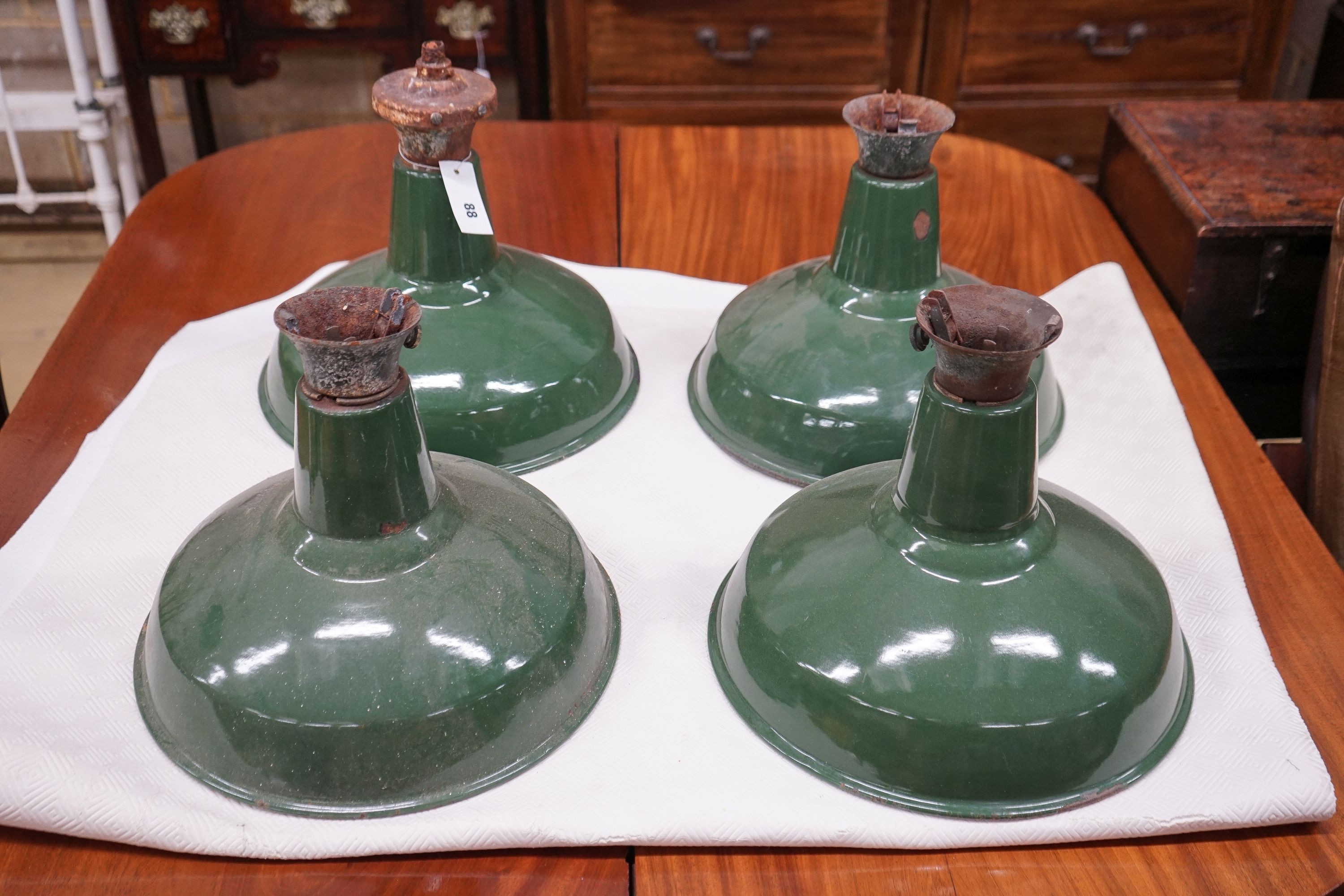 A set of four industrial style green enamelled ceiling shades, diameter 36cm